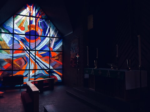 A vibrant church service in progress with joyful worshipers and colorful stained glass windows.