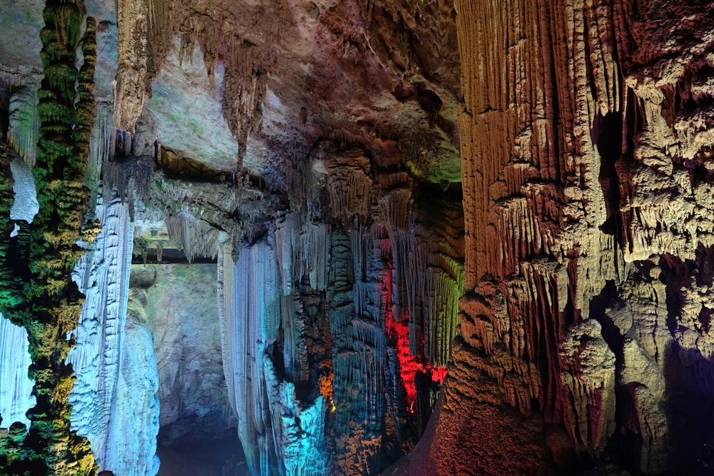 a group of people standing inside of a cave