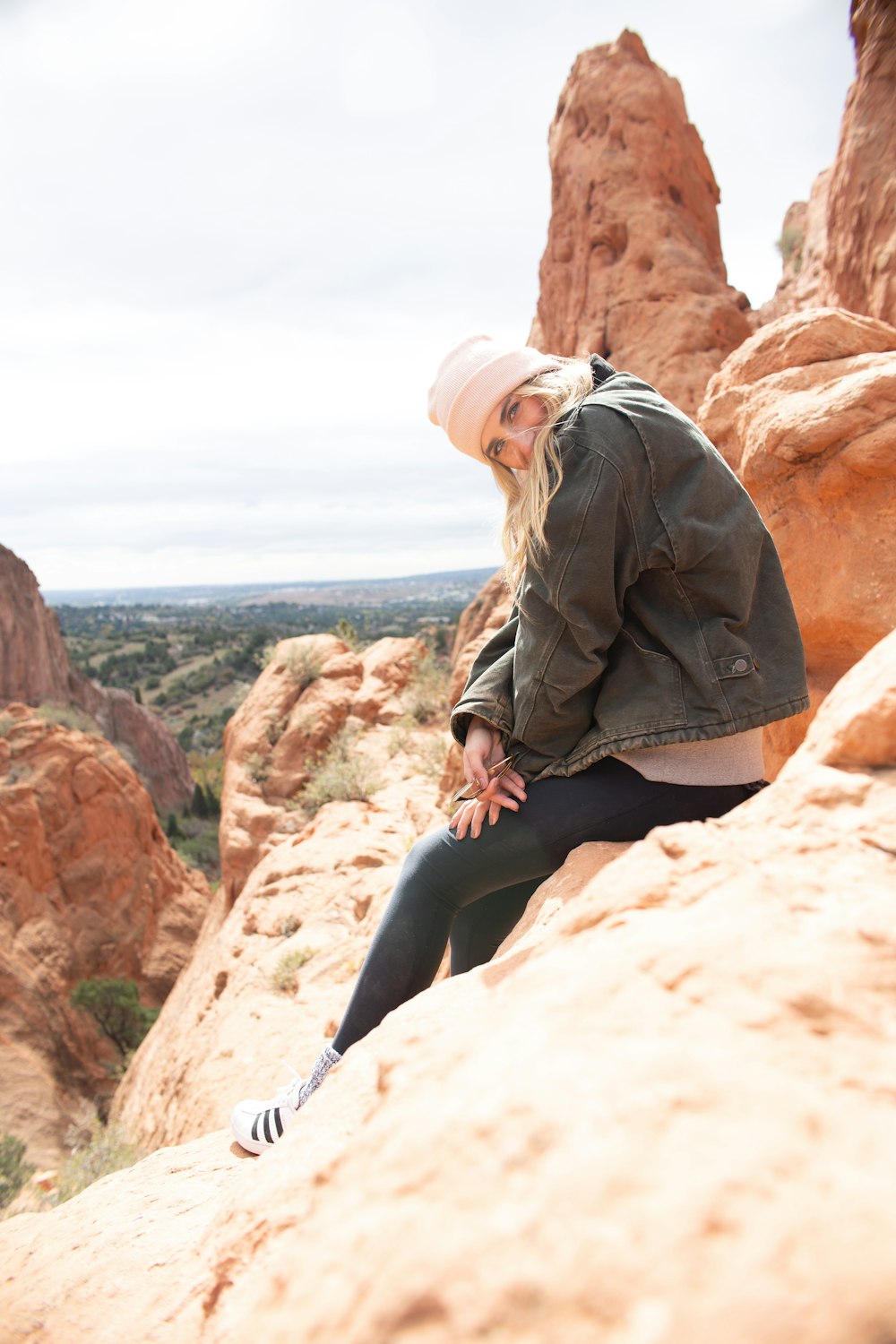 woman sitting on beige stone during daytime