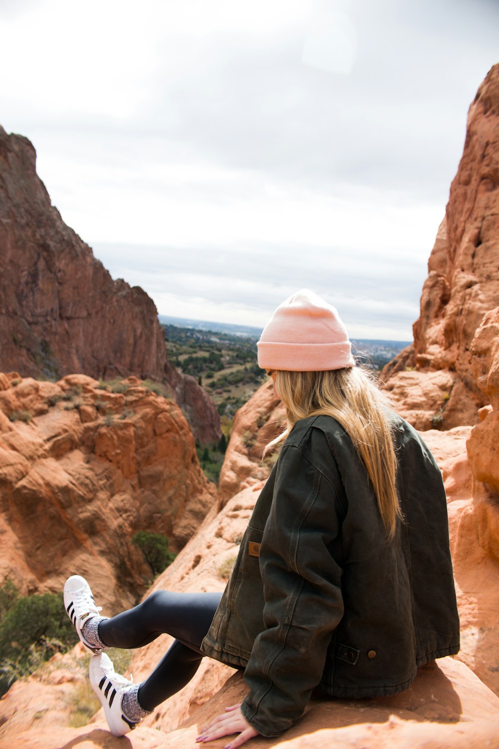 woman sitting on cliff