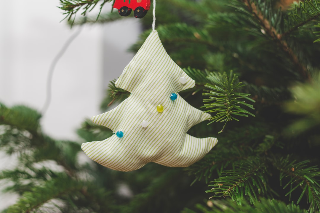 white Christmas tree ornament hanging on Christmas tree