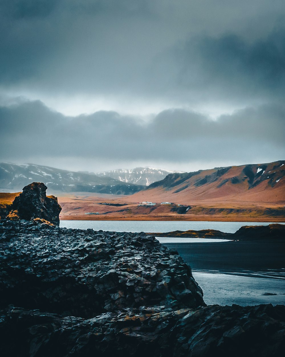 rock formation near body of water during daytime