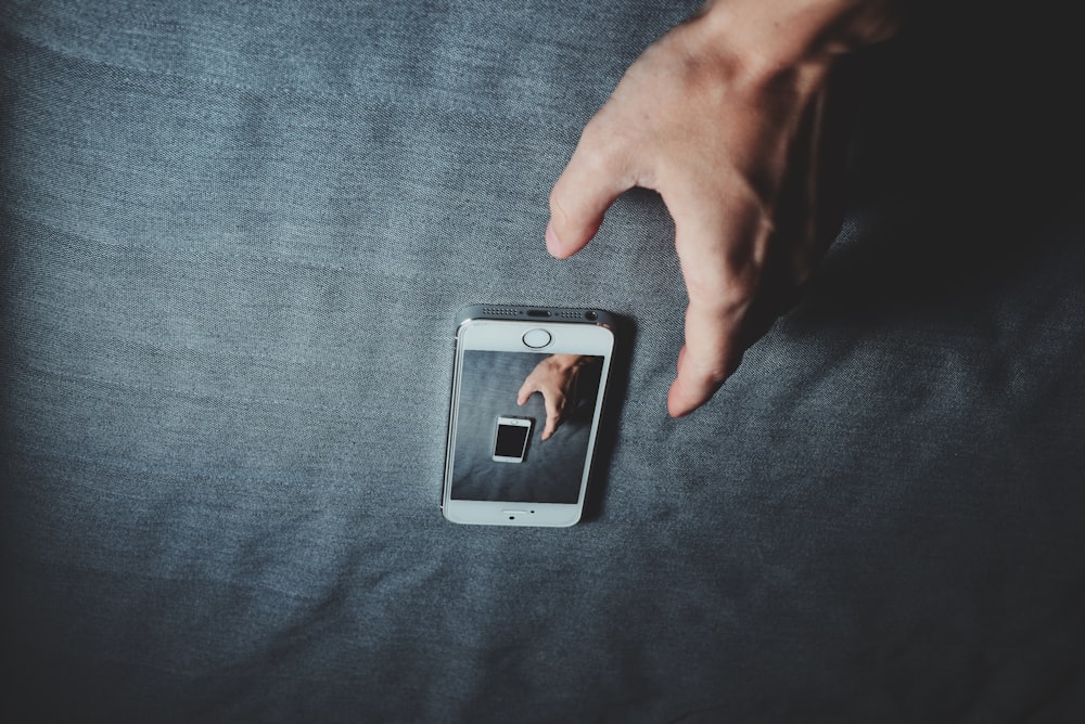 silver iPhone 6 on gray textile