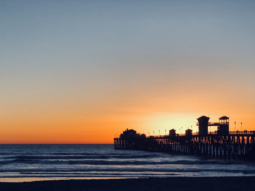 wooden dock under orange sky