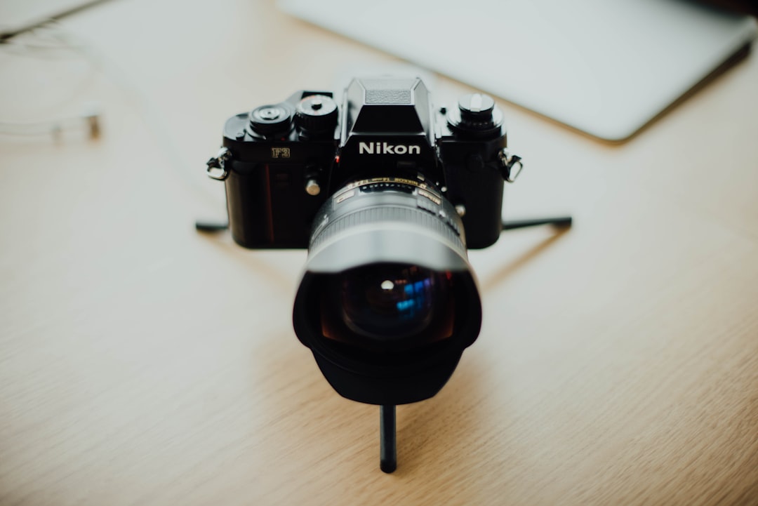 black Nikon DSLR camera on table