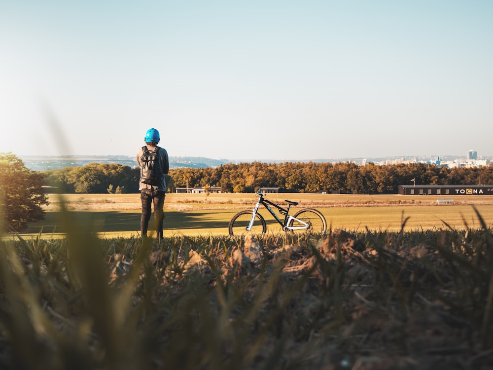 man standing on grass field