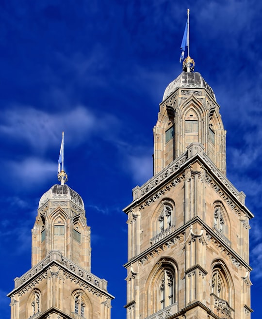 brown and white concrete buildings close-up photography in Grossmünster Switzerland