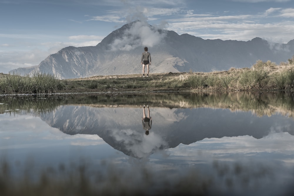 man standing near body of water