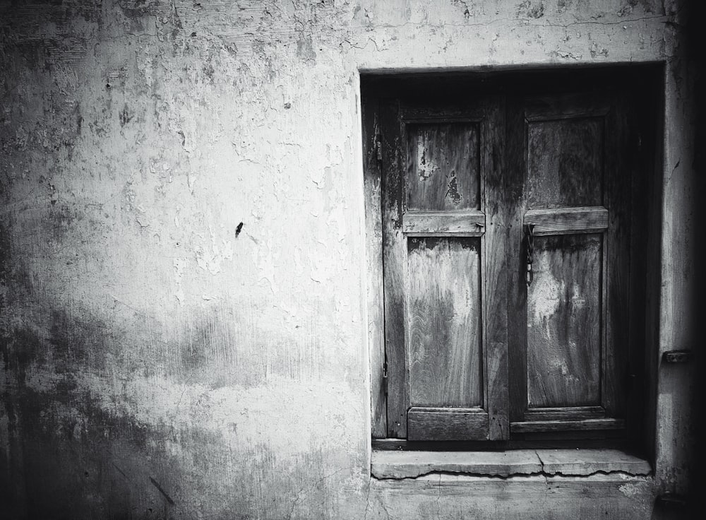 grayscale photography of closed window ahead