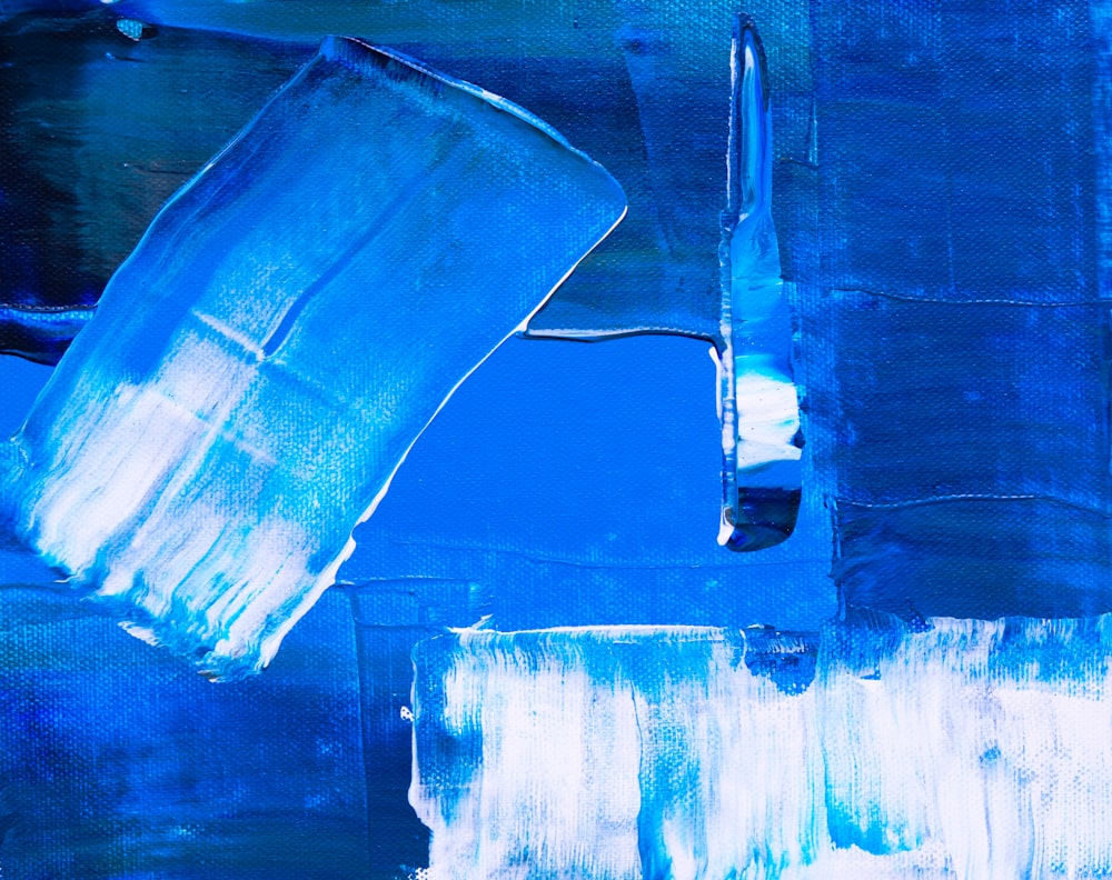 a painting of blue and white paint with a brush