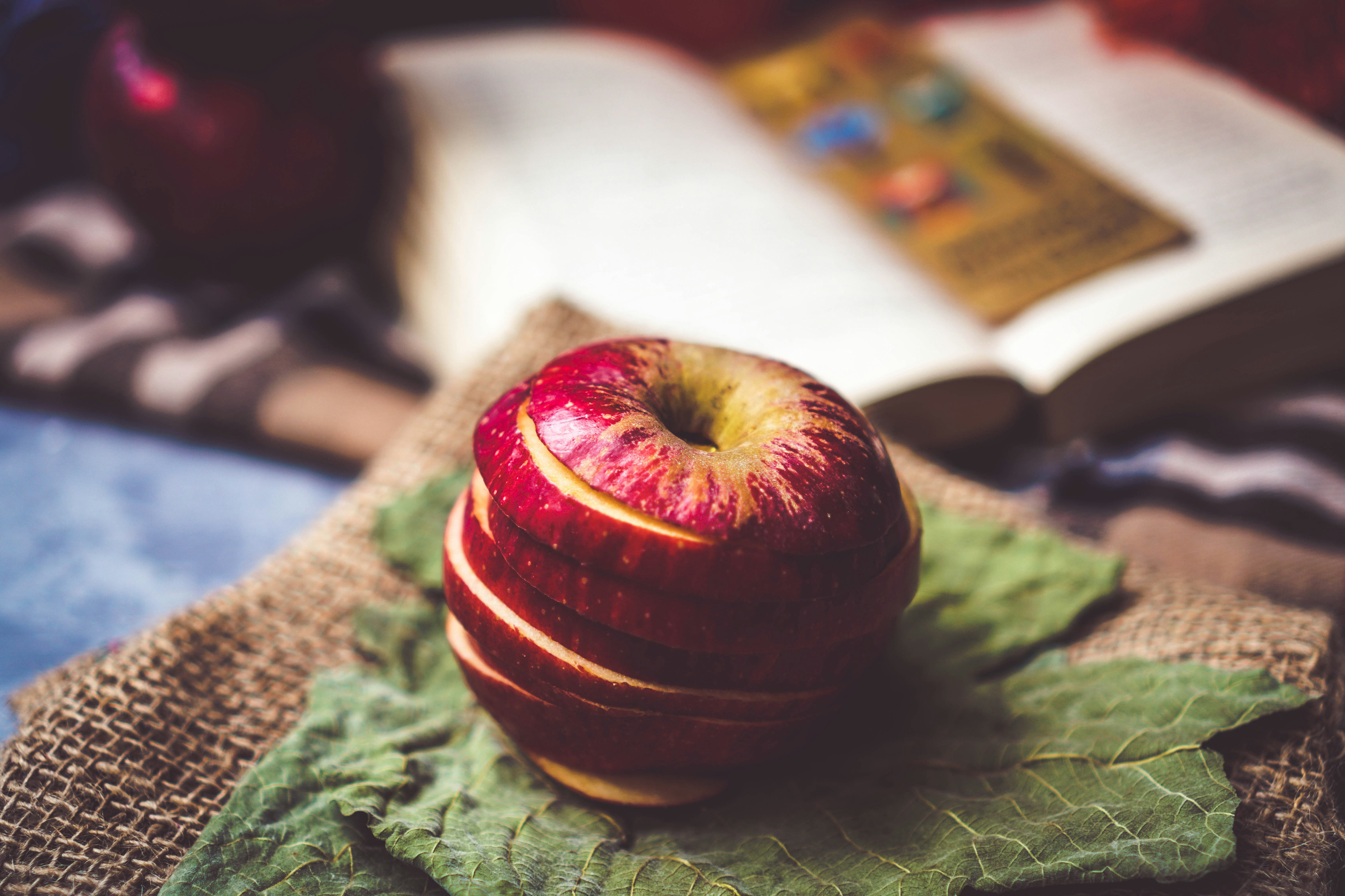 sliced apple fruit on green textile
