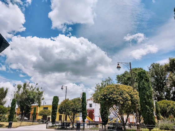A sunlit vintage-style photo of Day Street Park with people enjoying a warm summer day in 1969 San Francisco.