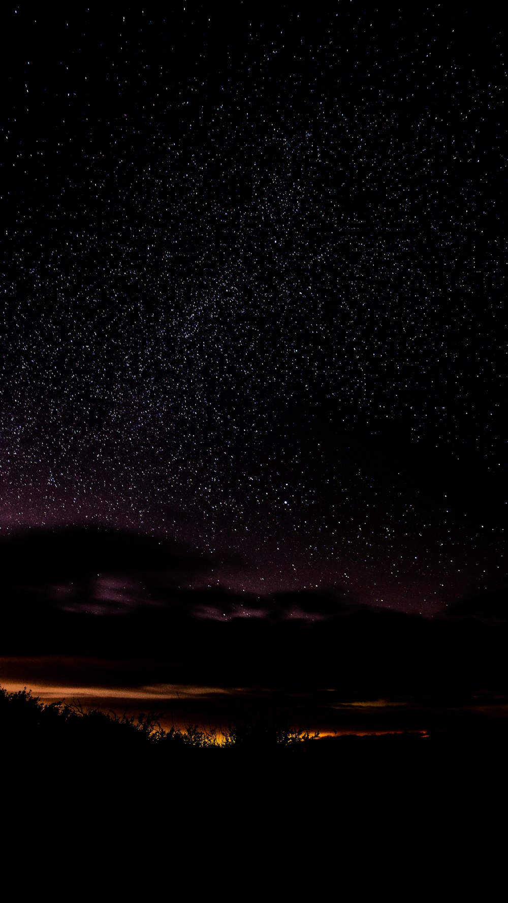 the night sky is filled with stars and clouds