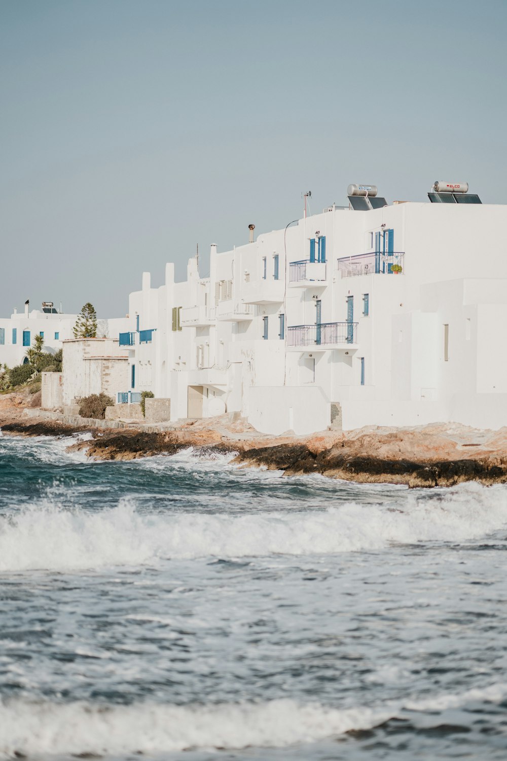 sea waves crashing on shore with house