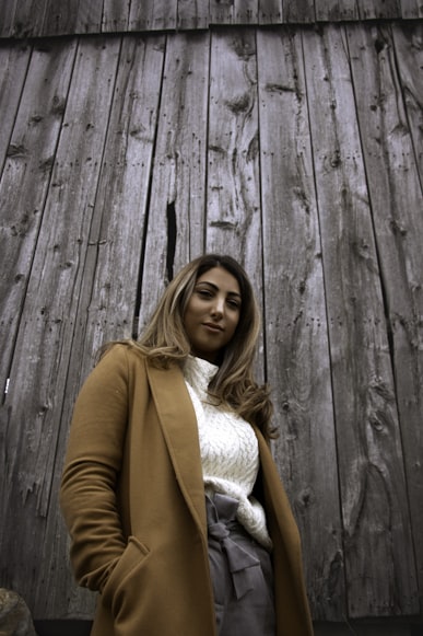 Woman in a brown coat photo by Catherine Roberge on unsplash.com