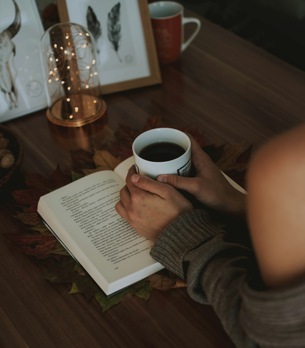 woman holding white mug