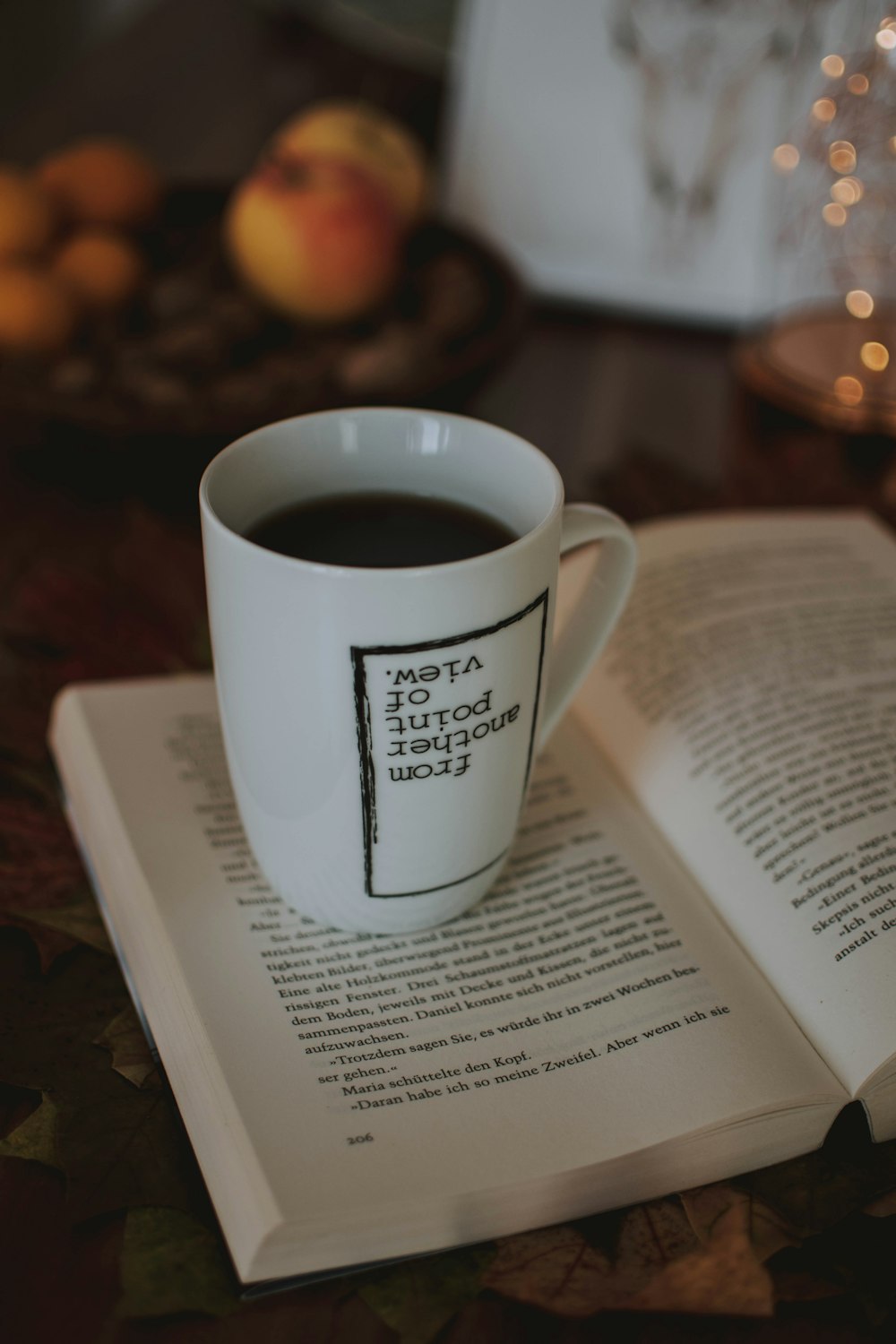 filled mug on opened book