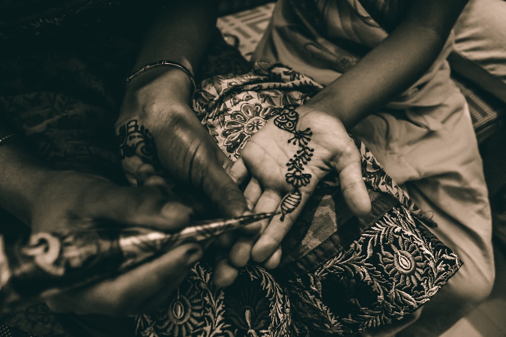 shallow focus photo of person with mehndi temporary tattoo