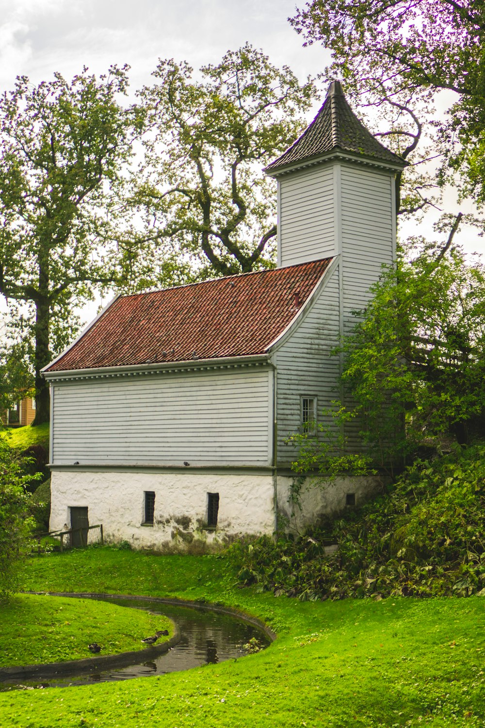 gray and brown house beside trees