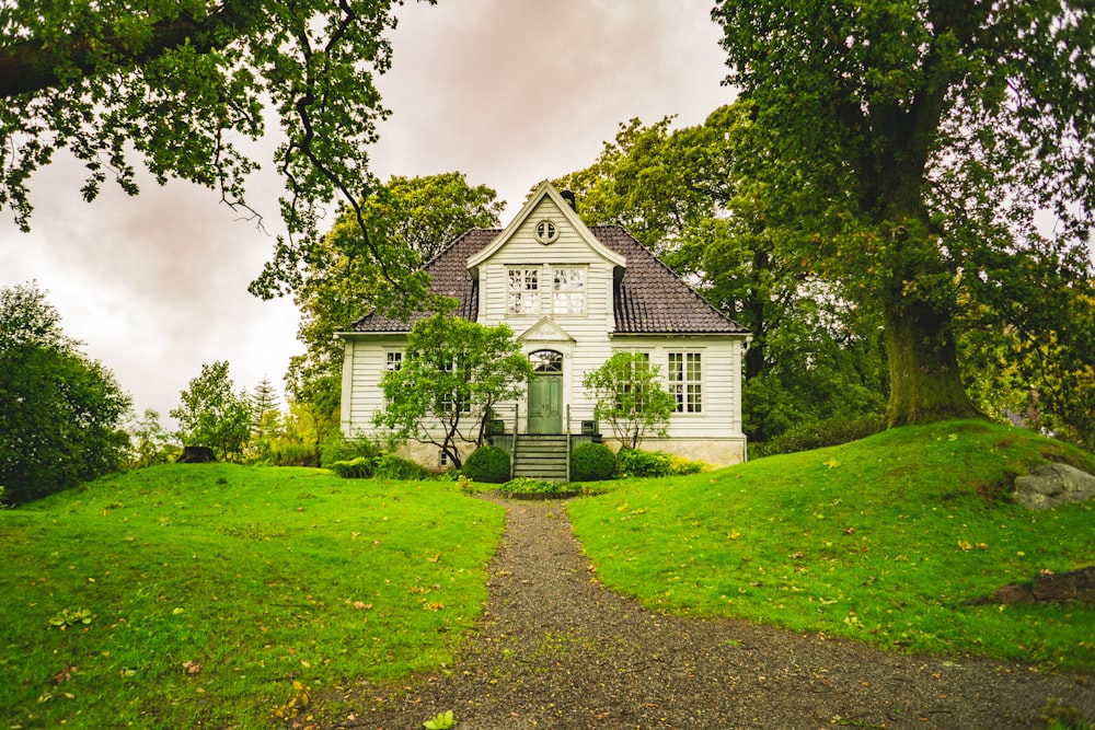 white and grey wooden house during daytime