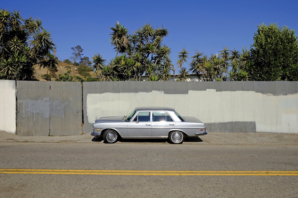 gray sedan parked near road