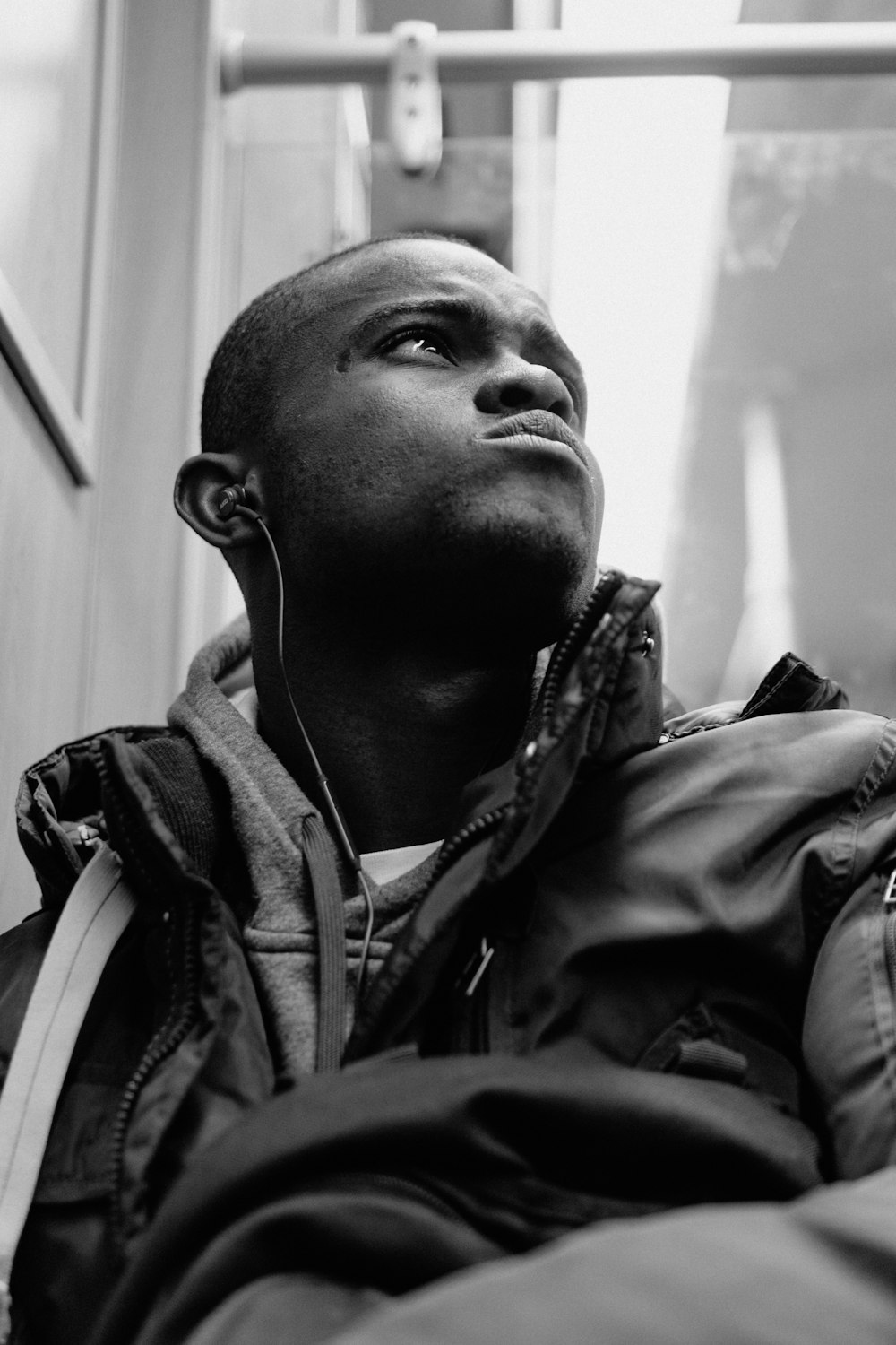 grayscale photography of man in jacket