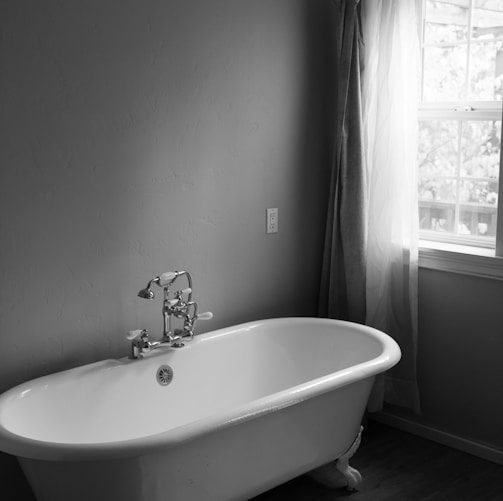 white ceramic bath tub inside room