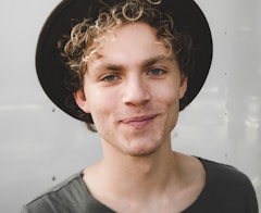 man standing near white wall