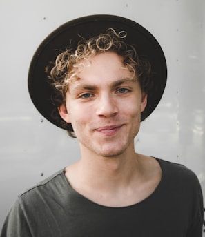 man standing near white wall