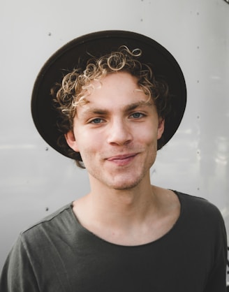 man standing near white wall