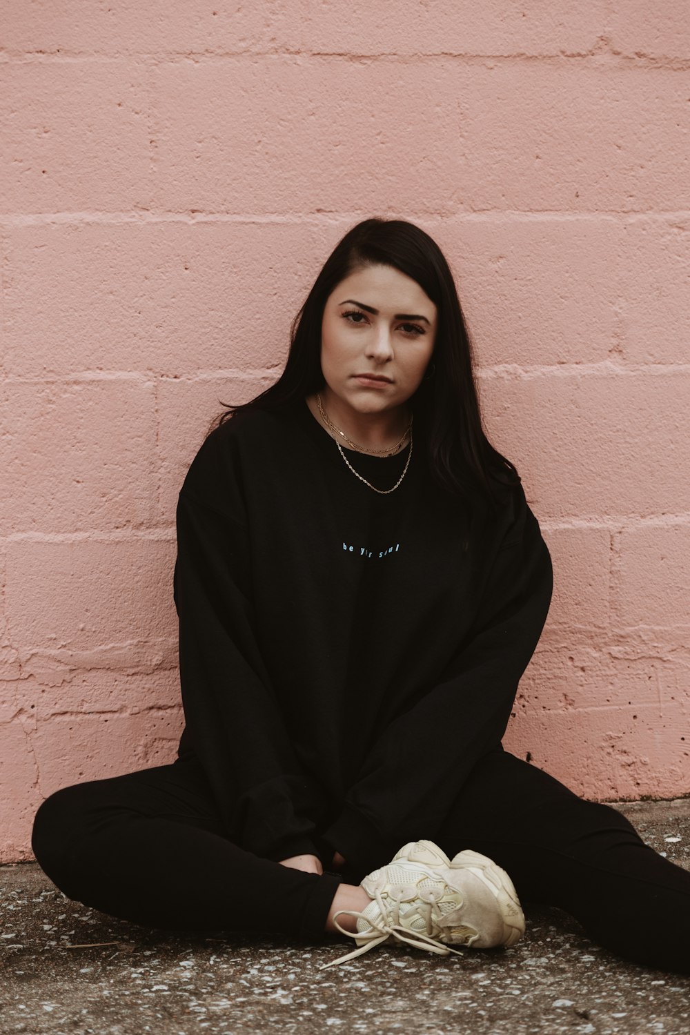 woman sitting near wall