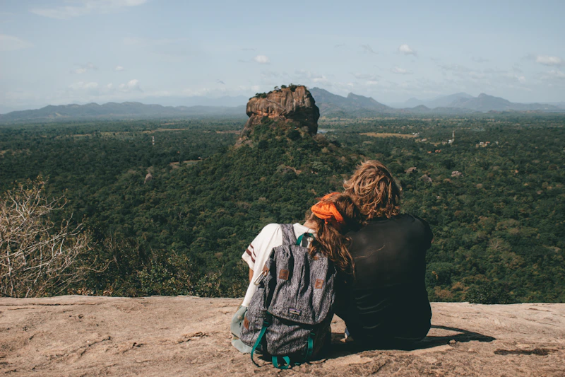 Sugar mama and sugar baby sitting beside a cliff, enjoying the view.