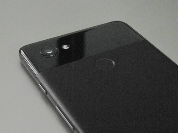 A close-up of a sleek smartphone with a clear screen protector and a stylish back cover.