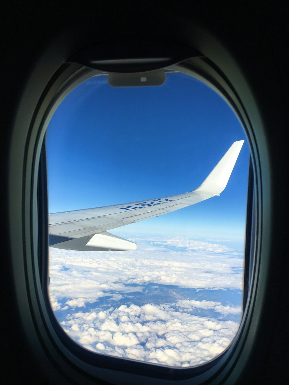 plane window showing airliner right wing