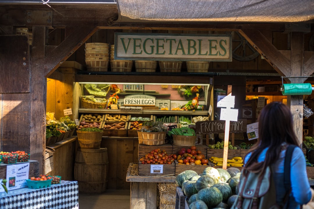 woman standing in front of vegetable stand