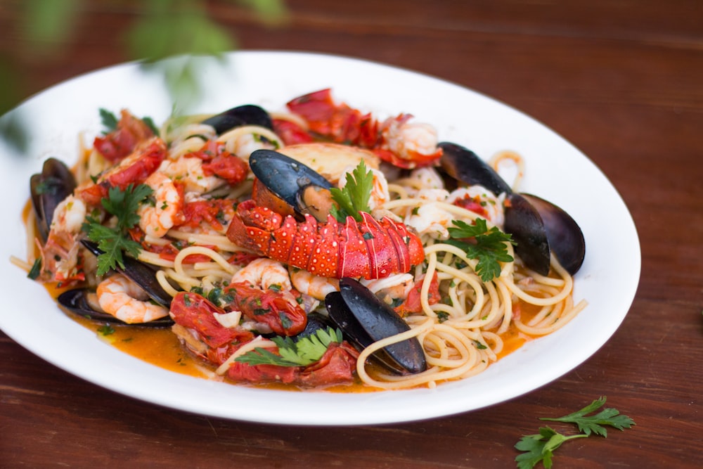 seafood pasta dish in white plate