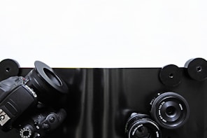 High-end camera equipment arranged neatly on a modern white table.