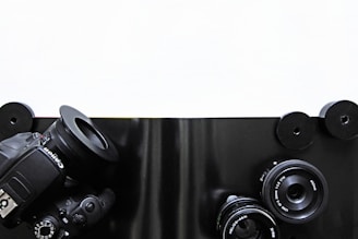 A sleek minimalist setup showing a camera on a tripod against a dark charcoal background.