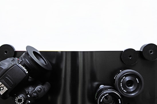 High-end camera equipment arranged neatly on a modern white table.