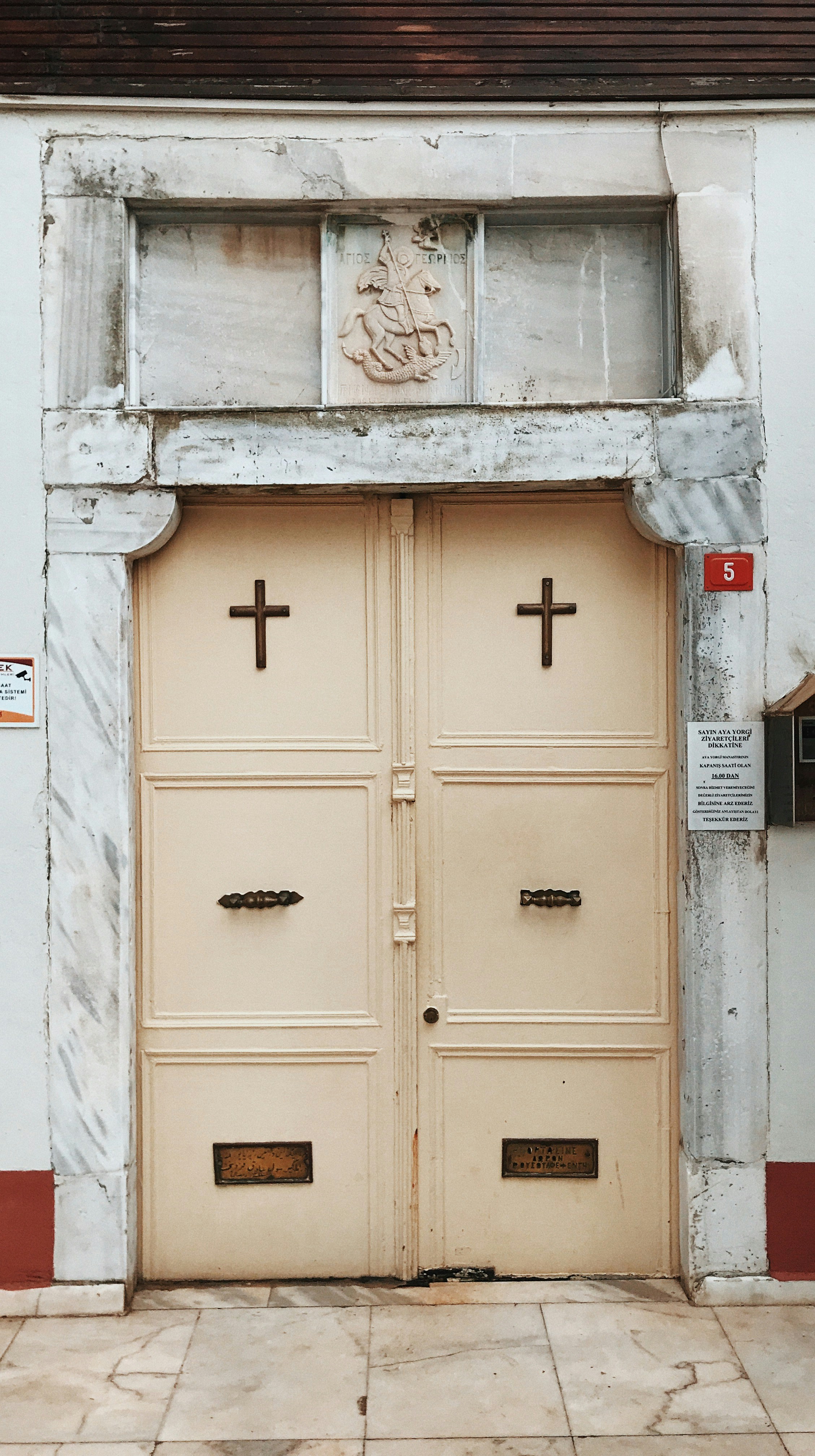 Two doors with crosses on them in front of a building photo Free Aya