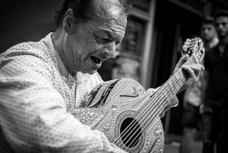 A man passionately playing an intricately decorated guitar in an outdoor setting. He appears to be deeply immersed in the music, with his eyes closed and mouth open, possibly singing. The scene captures a candid moment of emotional expression.