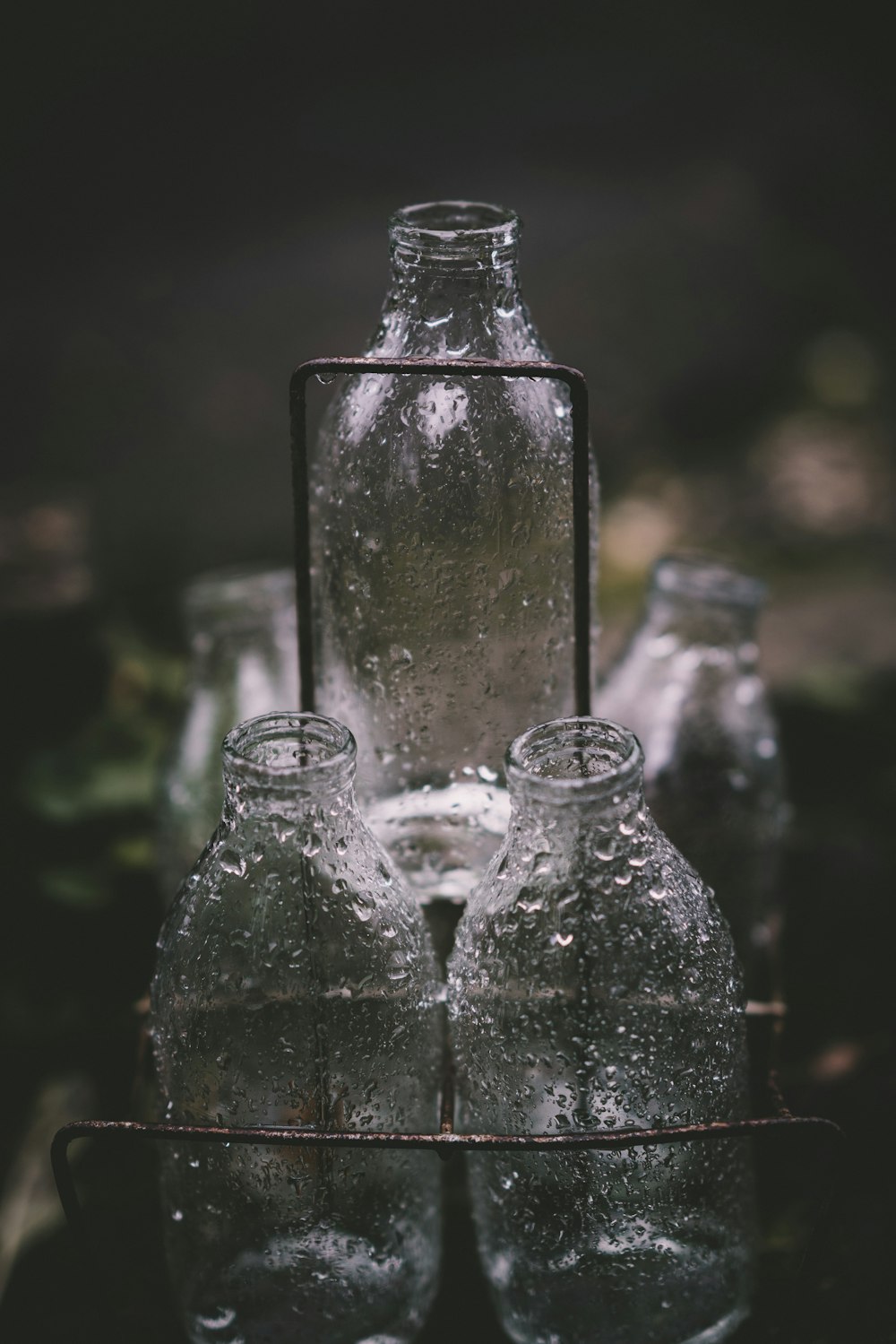 three glass bottles on rack