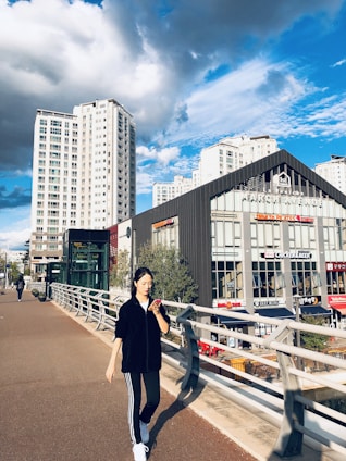 A person using the Sentinel app on their phone while walking through an urban street