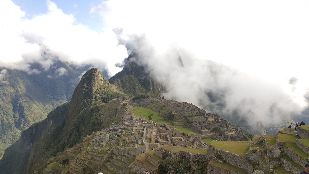 a group of people standing on top of a mountain