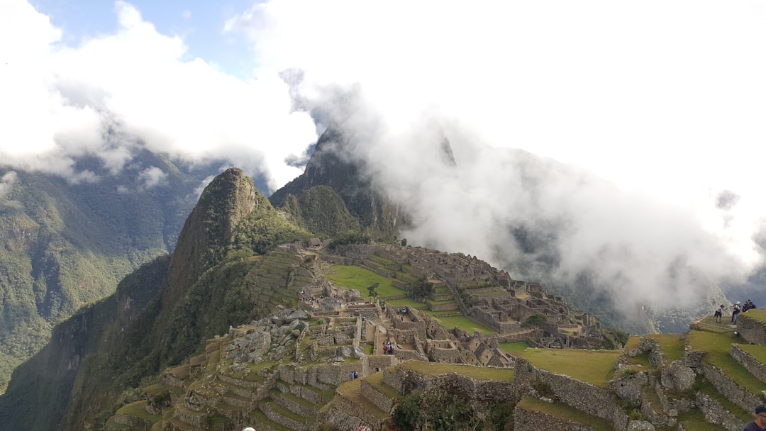 a group of people standing on top of a mountain, Top of Machu Picchu