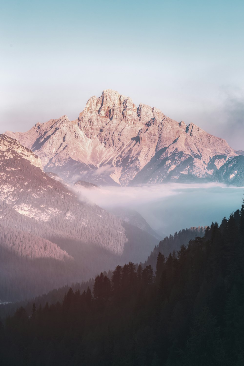 brown mountain and body of water during daytime