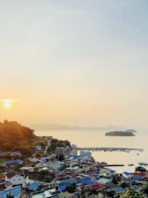 A vibrant coastal town in Santa Catarina during sunset, highlighting community life and natural beauty.
