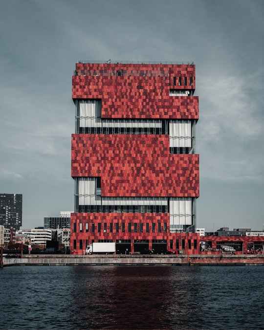 red and white concrete building near sea in Museum aan de Stroom Belgium