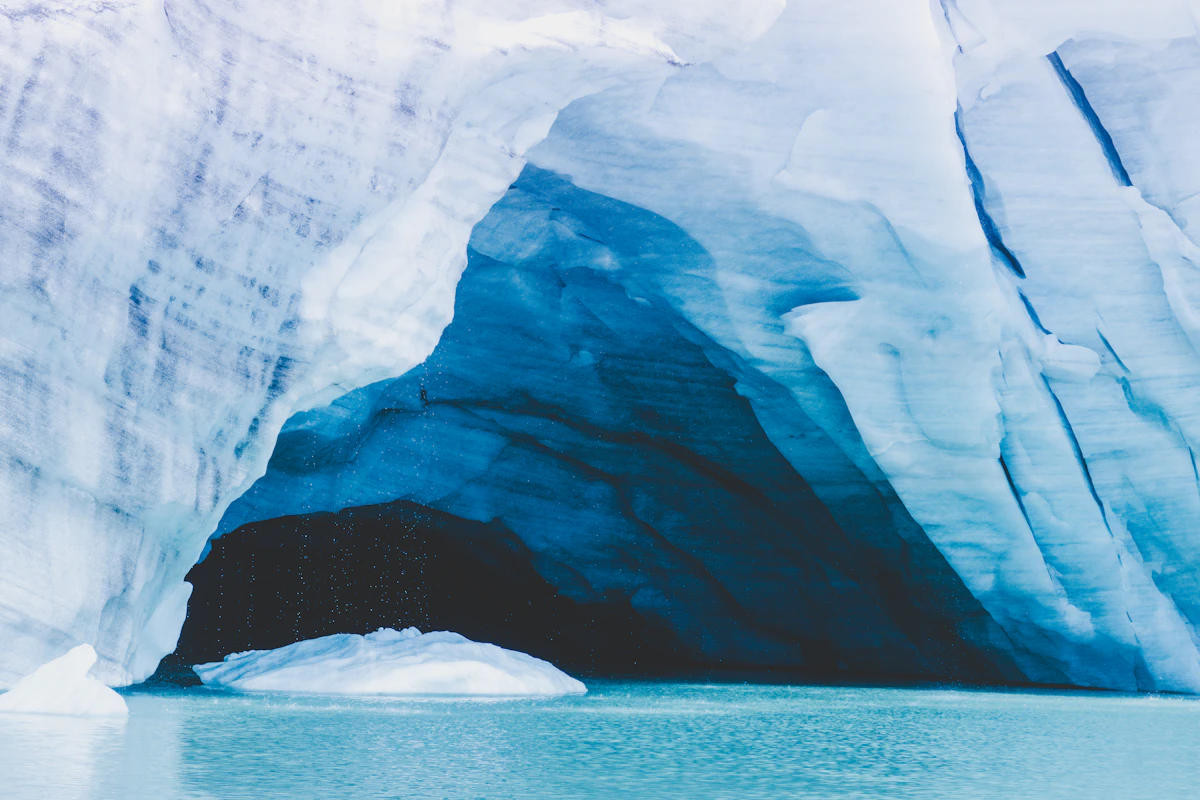 A massive iceberg floating in the ocean, most of its mass hidden beneath the surface