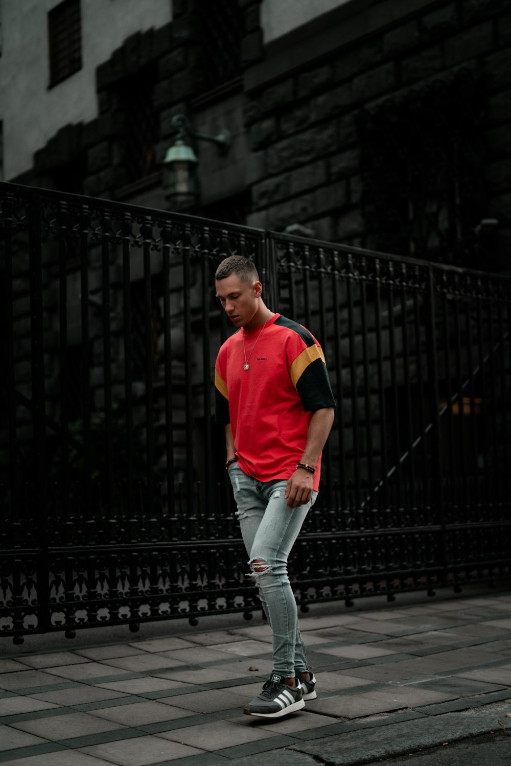 standing man wearing red and black t-shirt